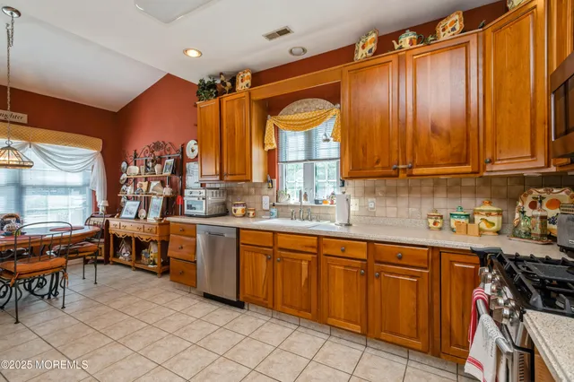 a open kitchen with stainless steel appliances granite countertop a sink and cabinets