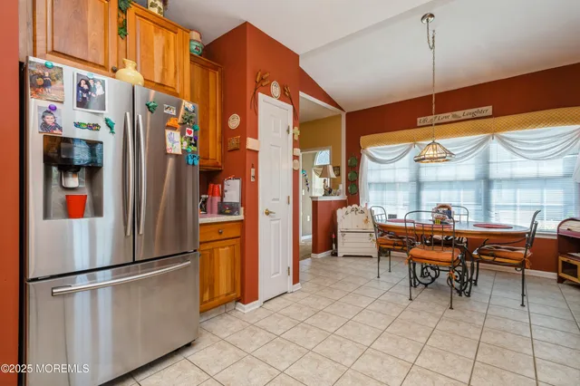 a kitchen with stainless steel appliances granite countertop a refrigerator and a table