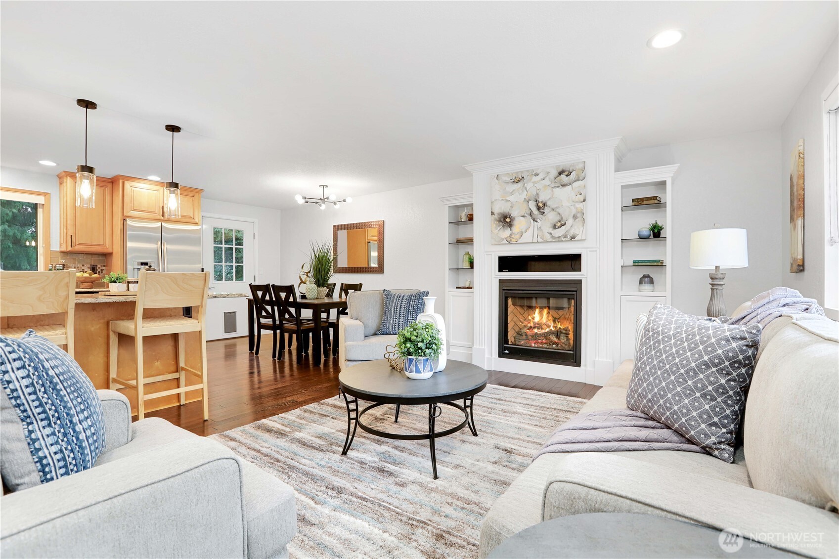 1822 171st Place Southeast Bothell, WA 98012 - Photo 3 of 36 a living room with furniture a fireplace and a chandelier