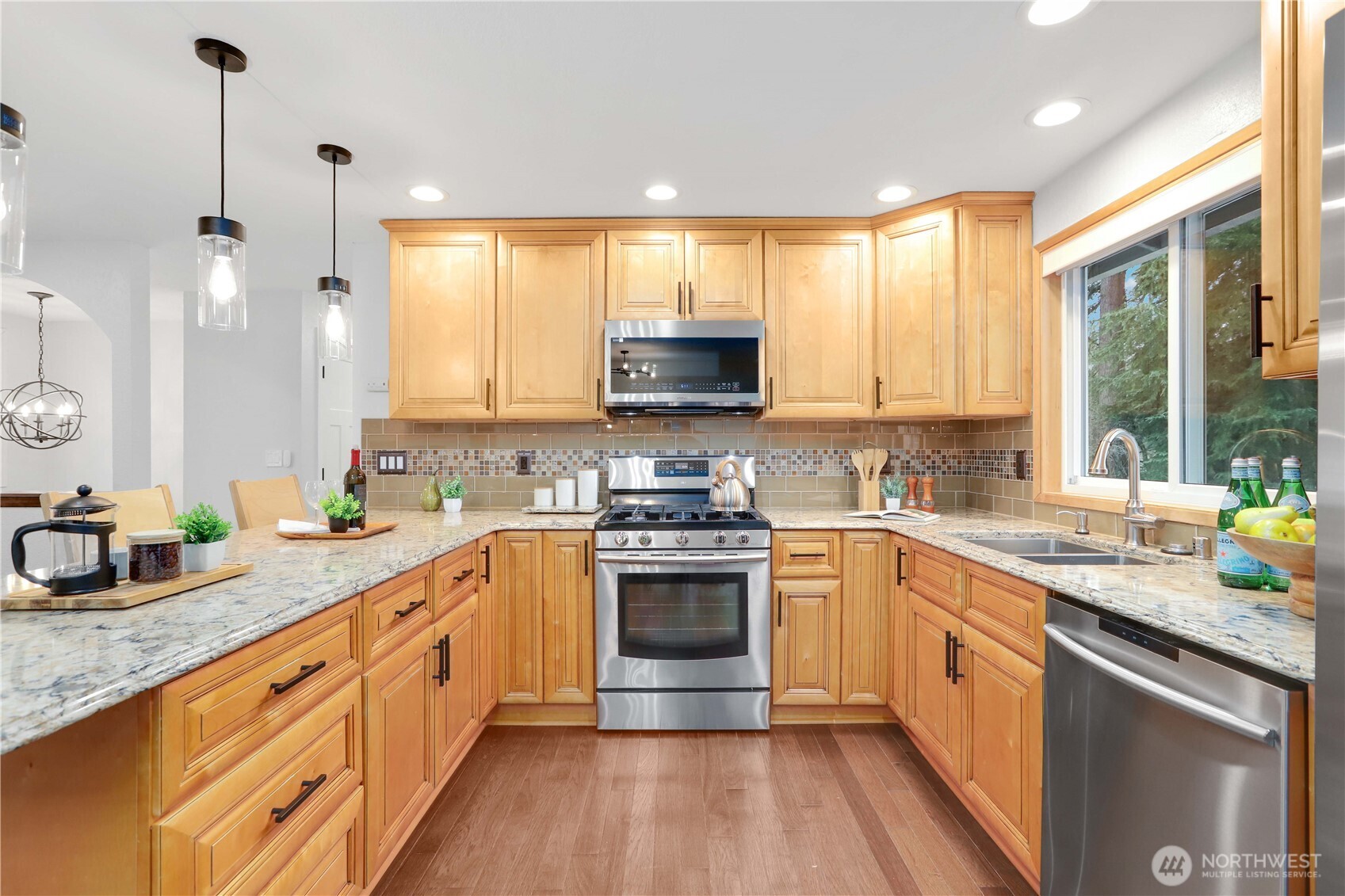 1822 171st Place Southeast Bothell, WA 98012 - Photo 6 of 36 a kitchen with stainless steel appliances granite countertop a stove a sink and a granite counter tops with white cabinets