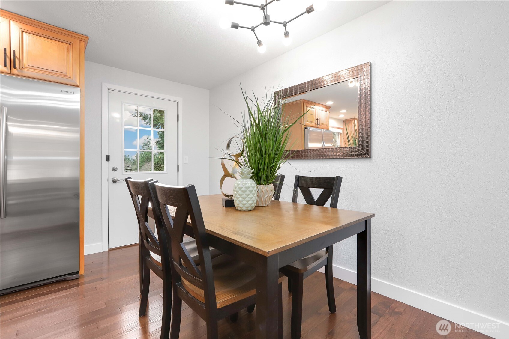 1822 171st Place Southeast Bothell, WA 98012 - Photo 8 of 36 a view of a dining room with furniture window and wooden floor