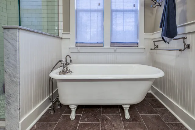 a white bath tub sitting in a bathroom