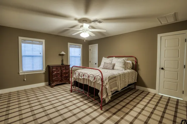 a bedroom with a bed and window