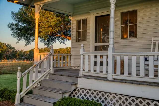 a view of a house with wooden fence