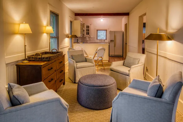 a living room with furniture and a lamp