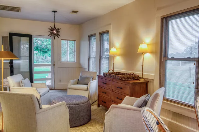a living room with furniture a window and a chandelier
