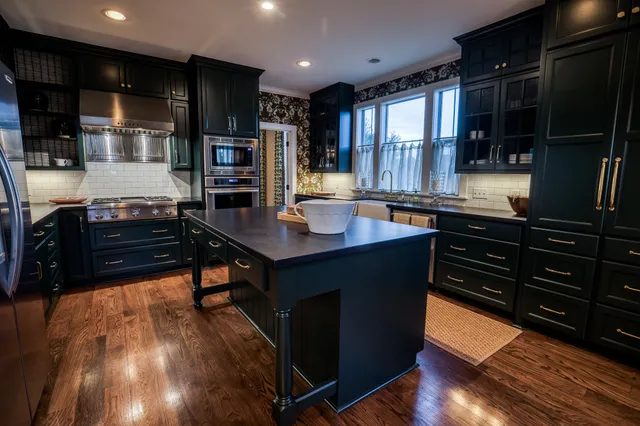 a kitchen with stainless steel appliances granite countertop a stove and a refrigerator