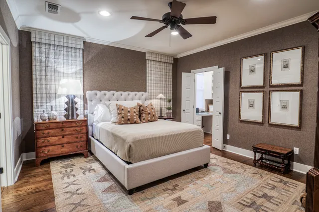 a bedroom with a bed wooden floor and window