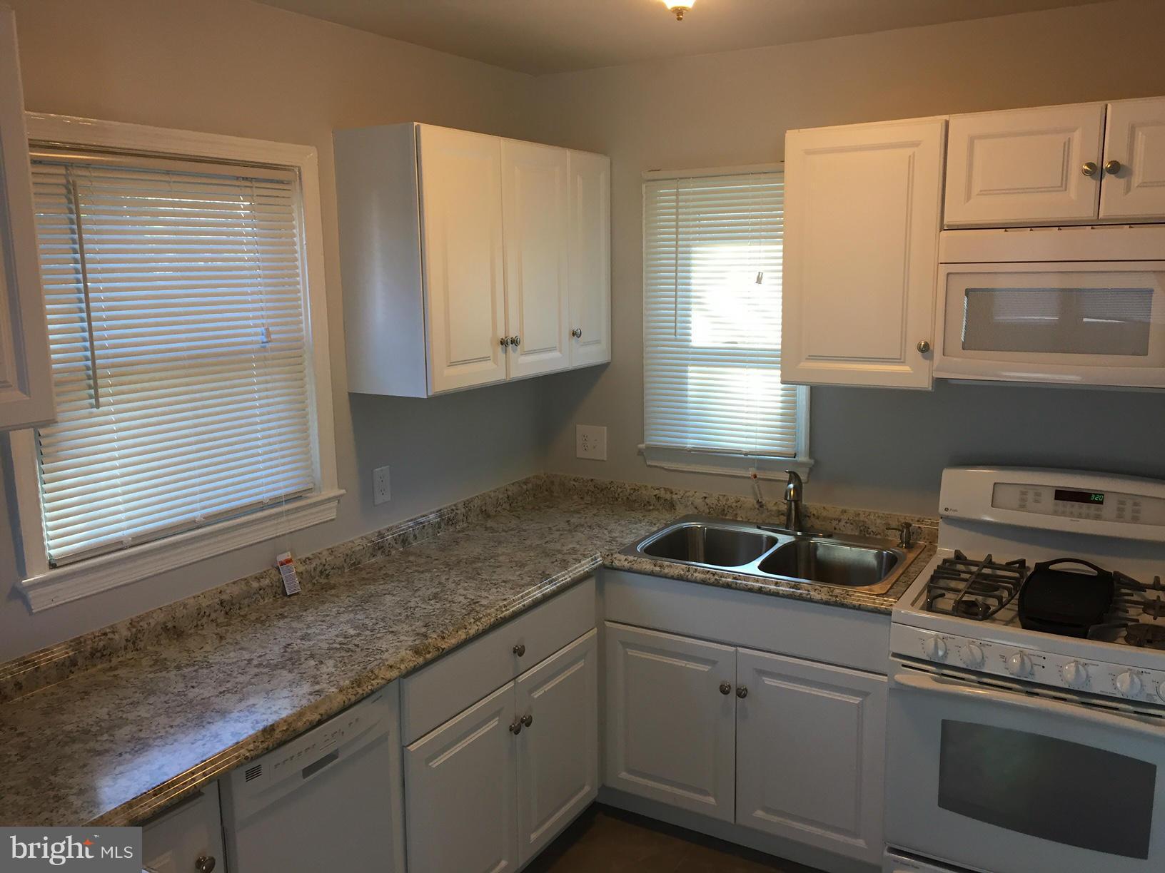 301 East Braddock Road Alexandria, VA 22301 - Photo 5 of 29 a kitchen with granite countertop a sink cabinets and window