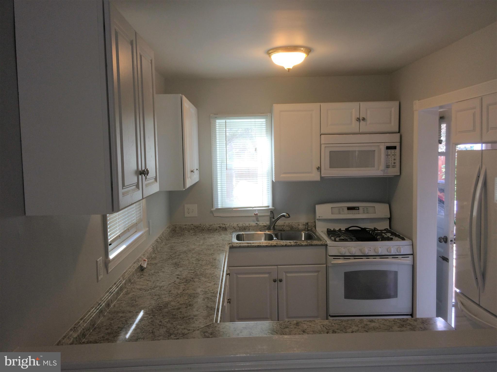 301 East Braddock Road Alexandria, VA 22301 - Photo 6 of 29 a kitchen with cabinets and appliances