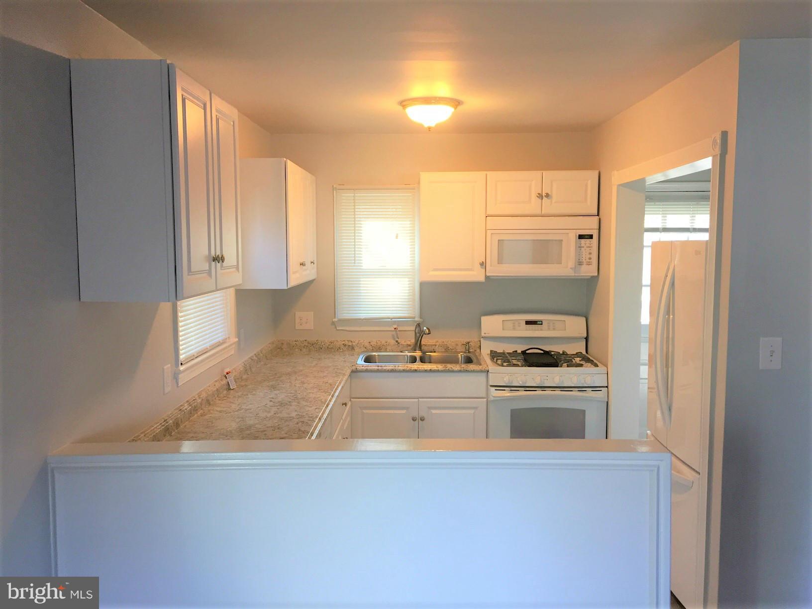 301 East Braddock Road Alexandria, VA 22301 - Photo 8 of 29 a kitchen with kitchen island a sink stove and refrigerator