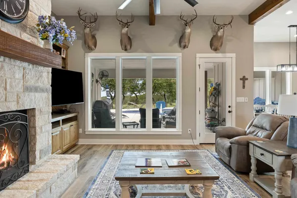 a living room with furniture a flat screen tv and a fireplace