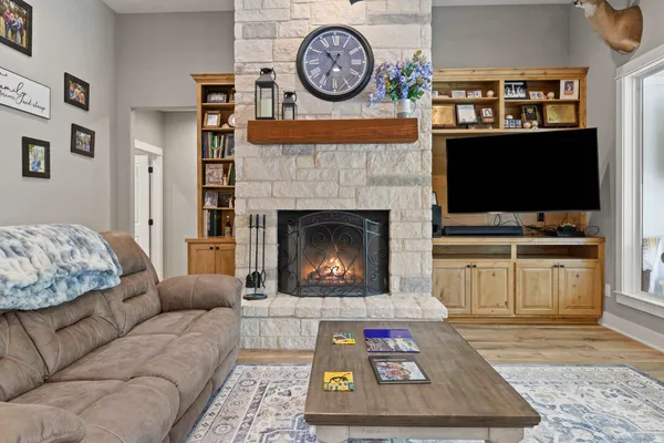 a living room with furniture and a fireplace