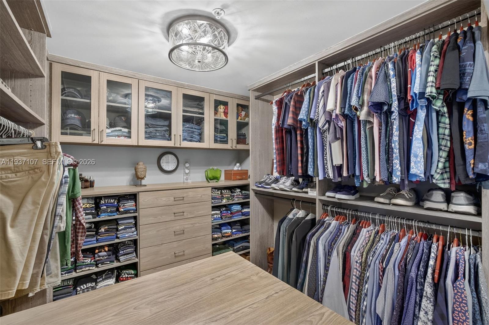100 South Birch Road, Unit 1103F Fort Lauderdale, FL 33316 - Photo 40 of 80 Custom walk in primary closet w/ tons of drawers on both sides of island and glass uppers