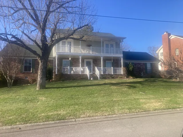 a front view of a house with a garden and swimming pool