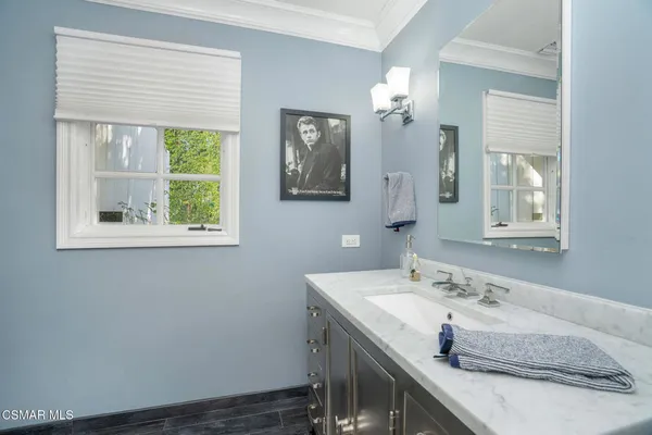 a view of a bathroom with a sink mirror and toilet