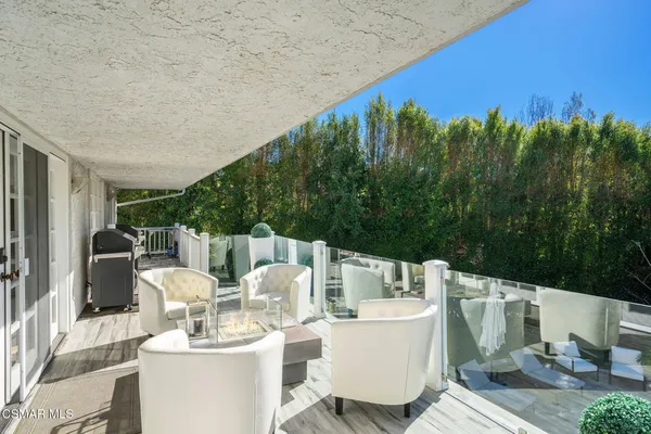 a balcony with table and chairs