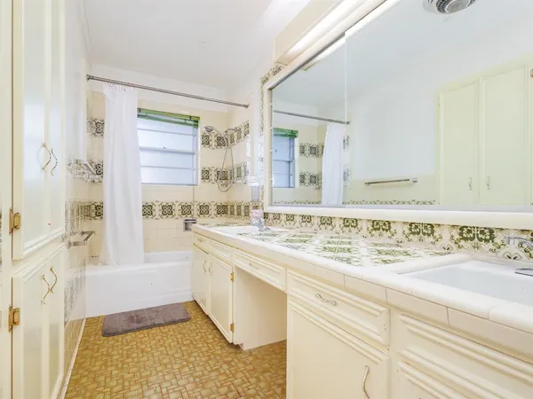 a bathroom with a sink a mirror and a bathtub