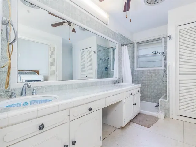 a bathroom with a granite countertop sink mirror and double