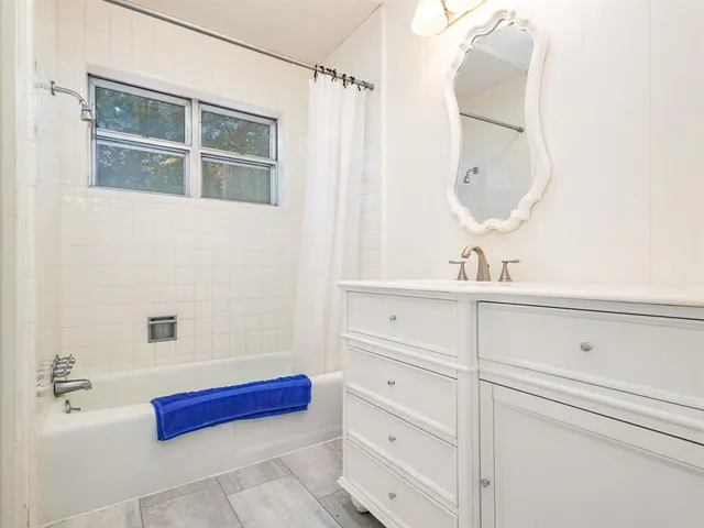 a bathroom with a mirror and a sink