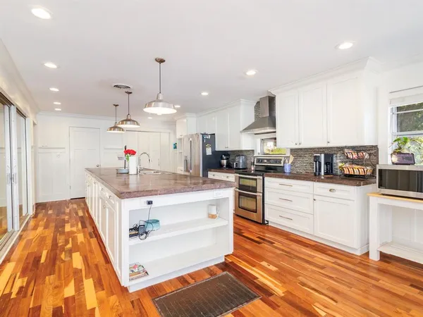 a kitchen with stainless steel appliances granite countertop a sink and cabinets
