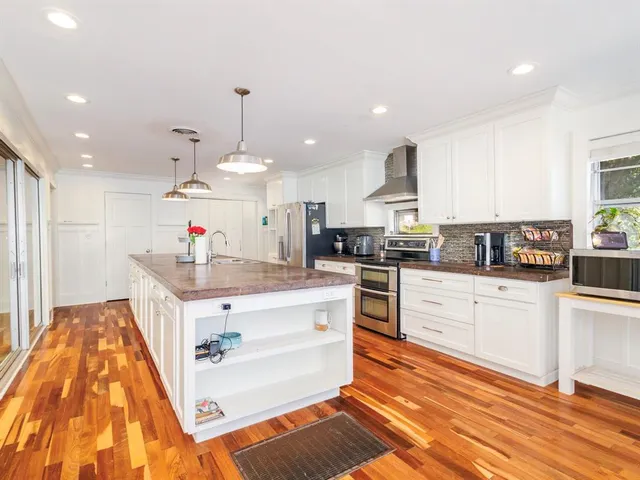 a kitchen with stainless steel appliances granite countertop a sink and cabinets