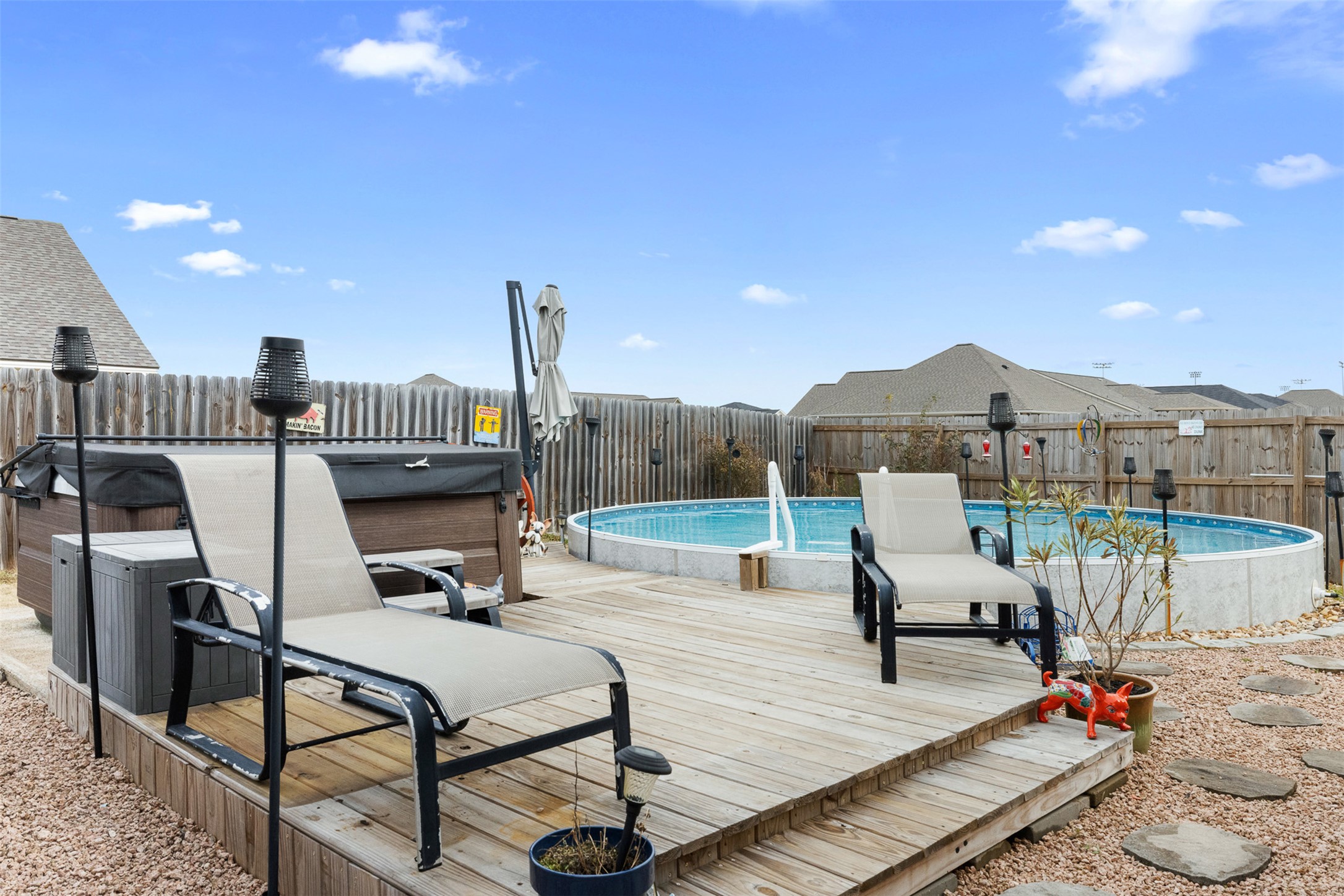 149 Windmill Road Somerville, TX 77879 - Photo 6 of 31 Deck with a hot tub and a fenced backyard