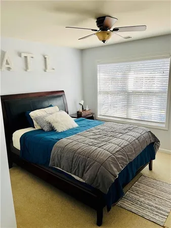 a bedroom with a bed and window