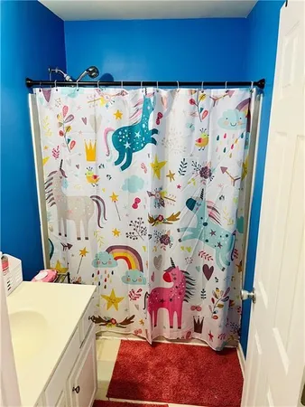 a bathroom with a sink and a curtain