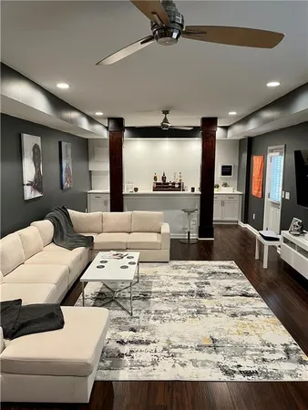 a living room with furniture and a large screen