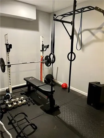 a room with gym equipment and white walls
