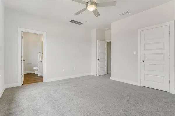 a bedroom with a bed and glass window