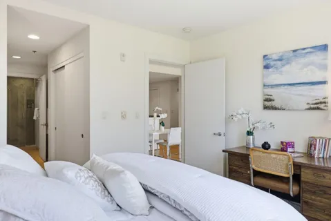a bedroom with a bed and a table in it