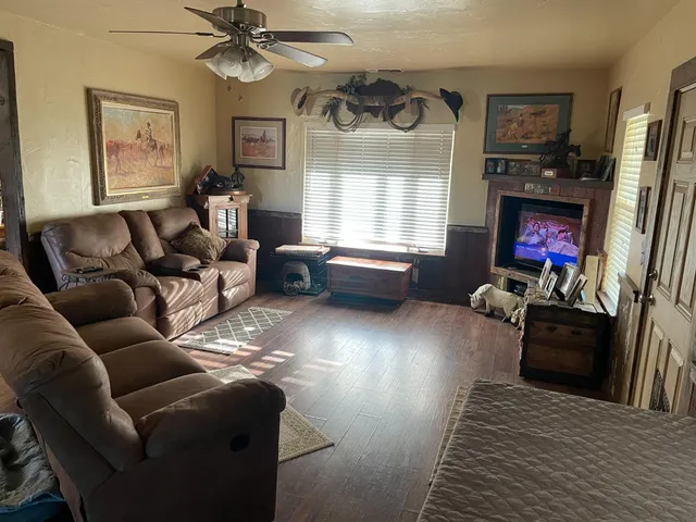 a bedroom with a bed and a flat tv screen on dresser