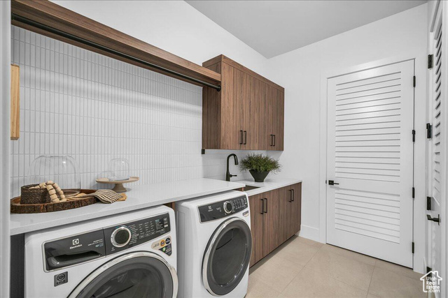 2761 West Lava Hls Road Santa Clara, UT 84765 - Photo 19 of 53 Laundry room with light tile patterned floors, washing machine and clothes dryer, and cabinet space