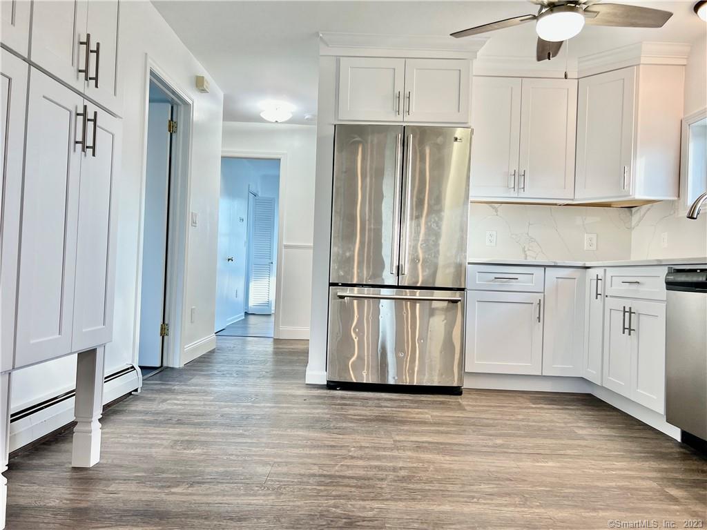 a kitchen with white cabinets and stainless steel appliances