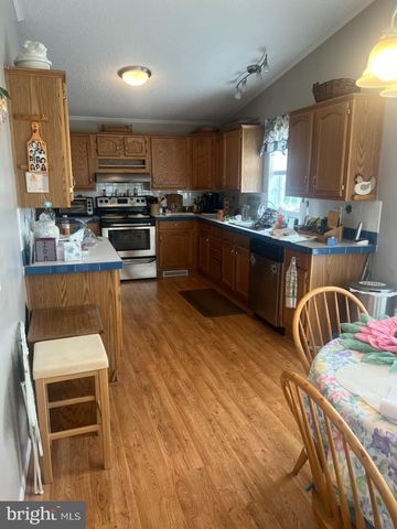 a kitchen with stainless steel appliances kitchen island granite countertop a stove a sink and a microwave