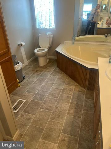 a bathroom with a sink toilet and window