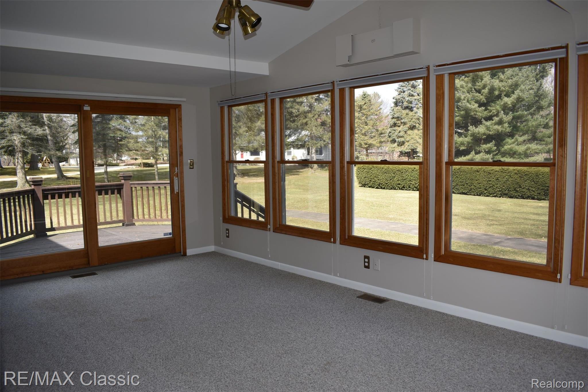 3980 Benstein Road Commerce Township, MI 48382 - Photo 22 of 68 Family room 19x11 with wrap around deck overlooking pool area and shuffle board court!