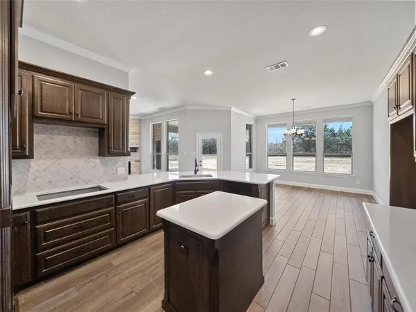 a kitchen with a sink microwave and cabinets