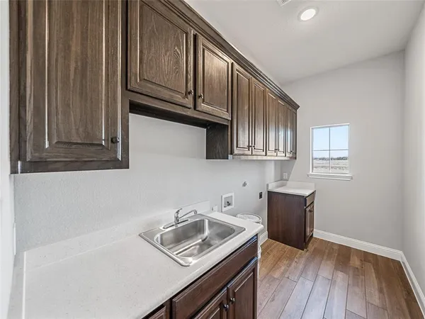 a kitchen with wooden cabinets and sink