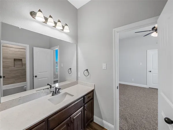 a bathroom with a sink a vanity and a mirror