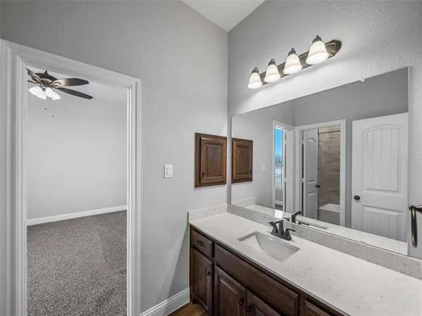 a bathroom with a double vanity sink and a mirror