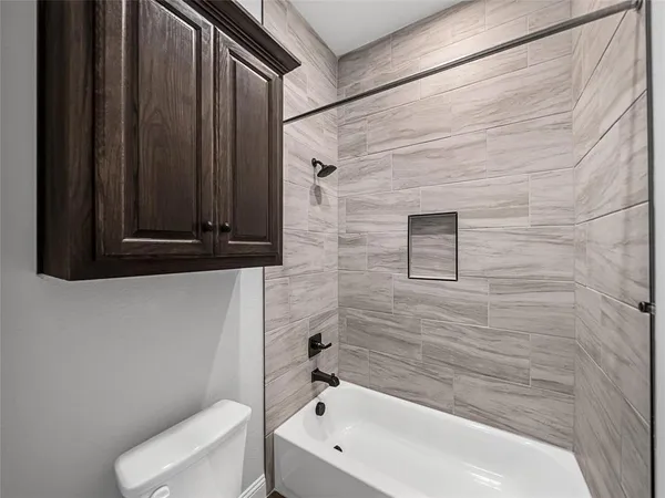 a bathroom with a bathtub and a toilet