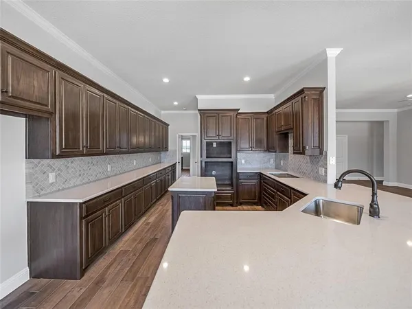 a kitchen with stainless steel appliances granite countertop a sink stove and cabinets