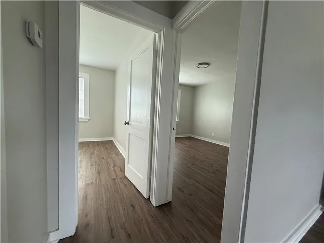 a view of a hallway with wooden floor