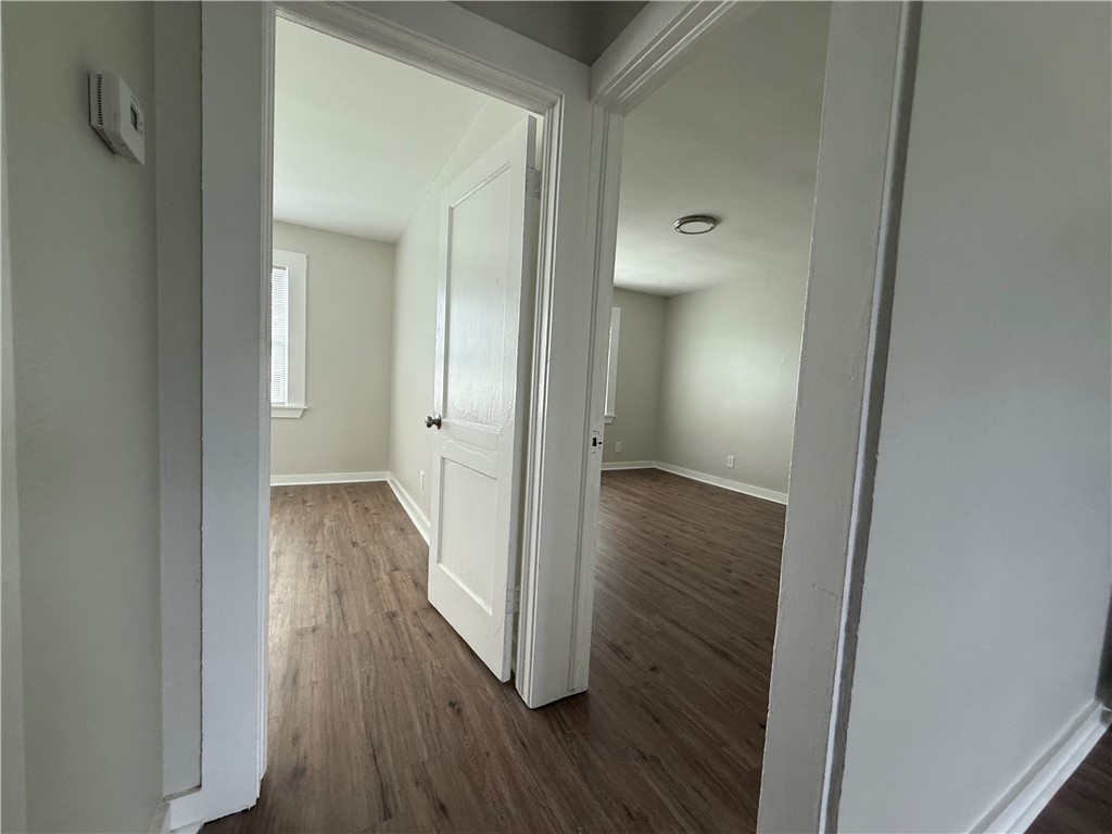 210 O'Neal Avenue, Unit A Sinton, TX 78387 - Photo 13 of 15 a view of a hallway with wooden floor