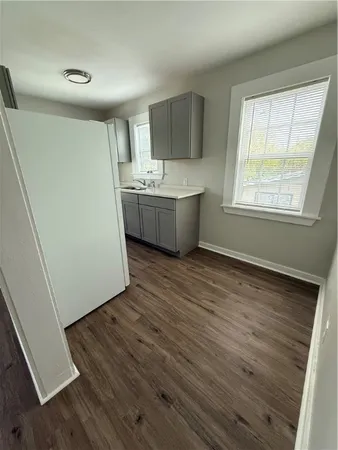 a view of a kitchen with wooden floor and electronic appliances