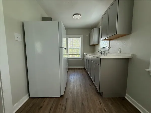 a kitchen with a refrigerator and a sink