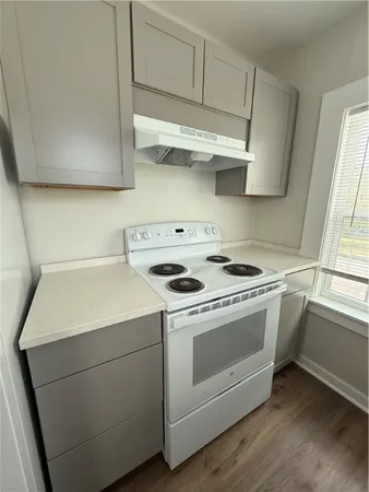 a stove top oven sitting inside of a kitchen